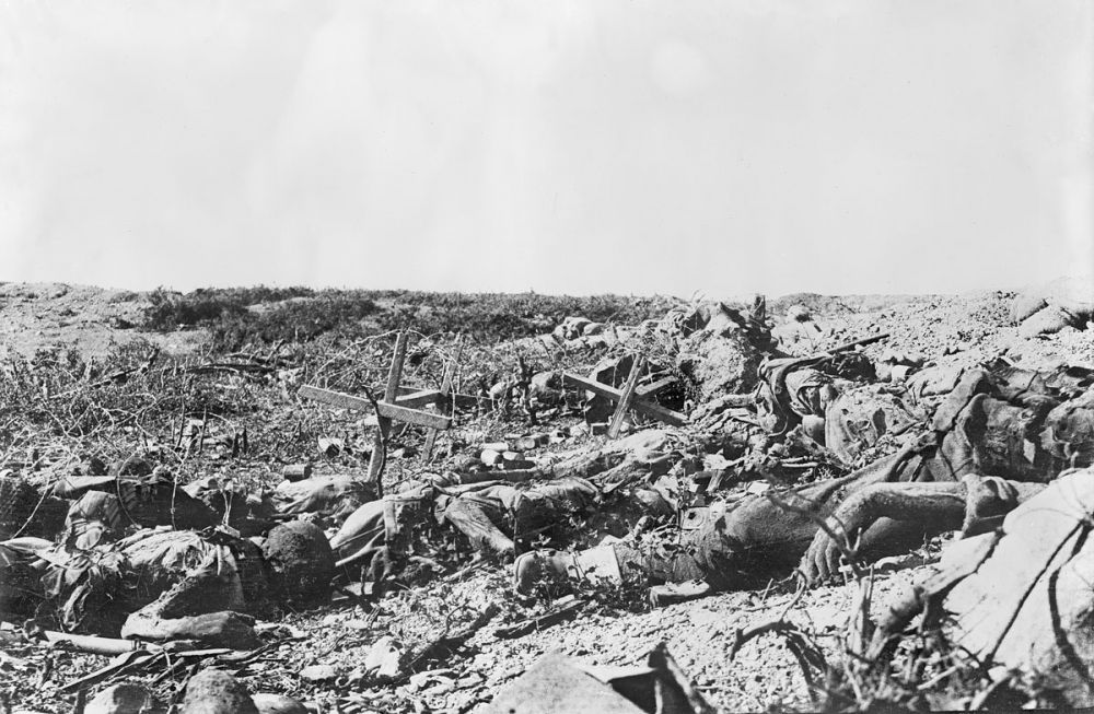 Looking back from Lone Pine to where the attack commenced. Two corpses are lying in the foreground amid debris and barbed wire.